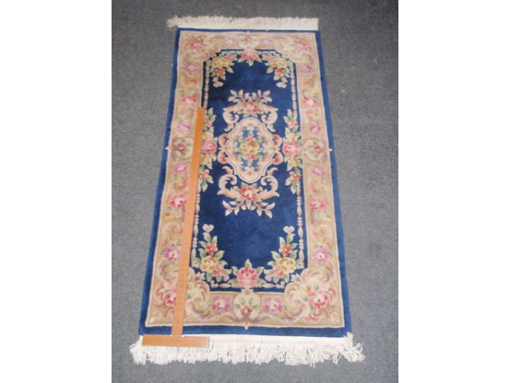 Appraisal: A blue ground Chinese handcut runner cm x cm