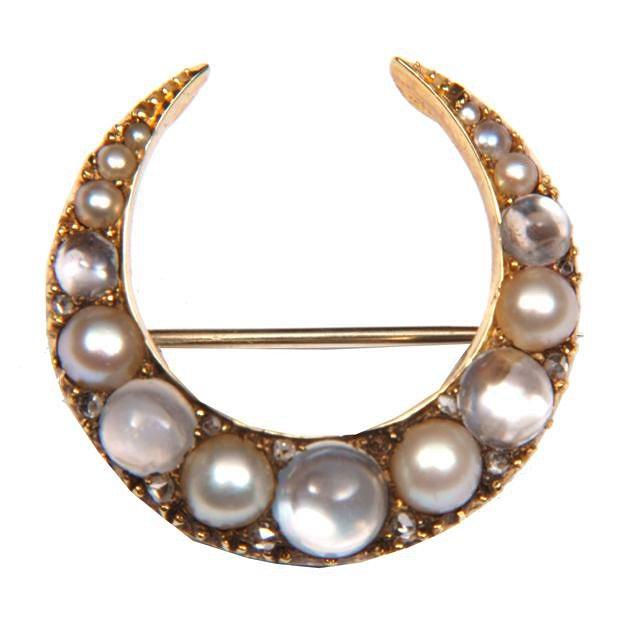 Appraisal: A MOONSTONE AND PEARL CRESCENT BROOCH graduated claw set stones