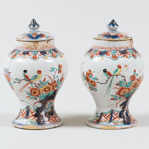 Appraisal: PAIR OF SMALL DUTCH POLYCHROME DELFT POTTERY JARS AND COVERSUnmarked