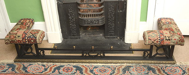 Appraisal: AN OLD IRON AND BRASS LOW CLUB FENDER with upholstered