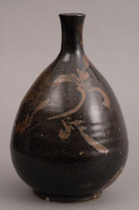 Appraisal: TZ'U CHOU BROWN-GLAZED POTTERY BOTTLE VASE The chocolate ground with