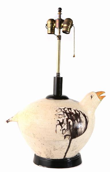 Appraisal: An earthenware lamp of bird form height to finial in