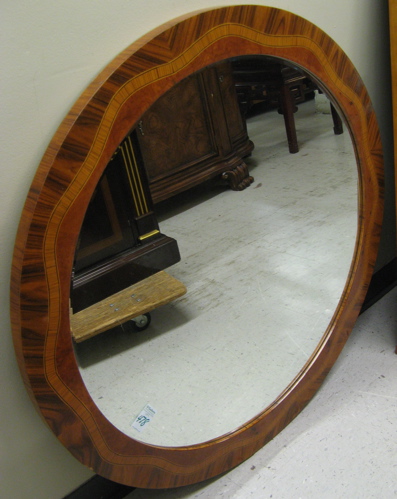 Appraisal: ROUND WALL MIRROR with banded walnut and burl walnut frame