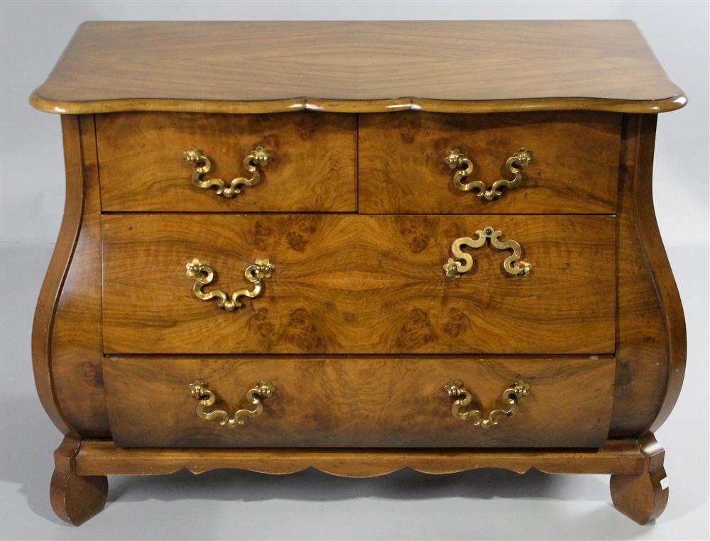 Appraisal: BAKER BURLED WALNUT BOMBE CHEST having a shaped rectangular molded