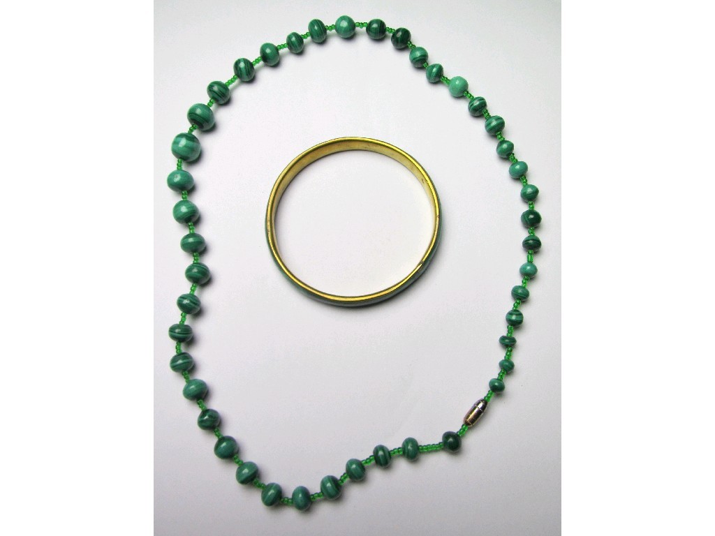 Appraisal: Lot comprising a malachite bangle and a string of malachite