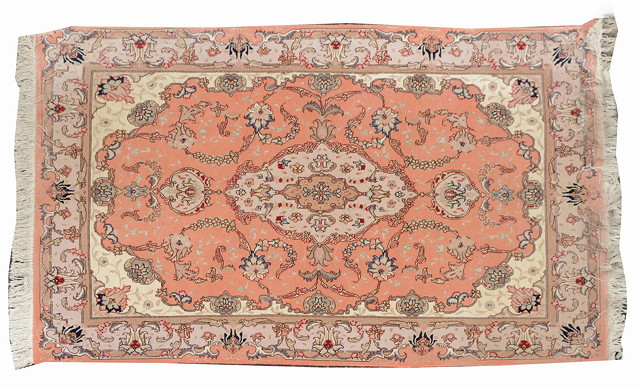 Appraisal: A PERSIAN PINK GROUND RUG decorated a central medallion within