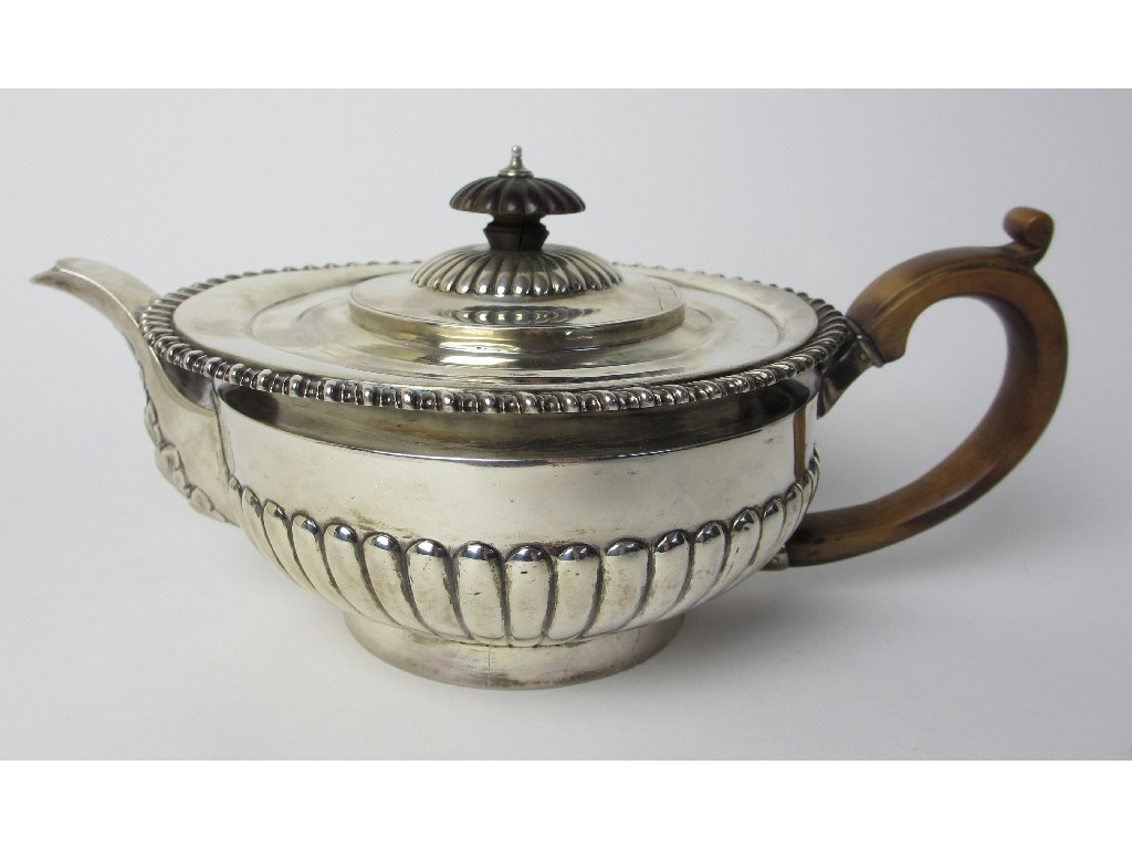 Appraisal: A Victorian silver teapot the half lobed body of squat