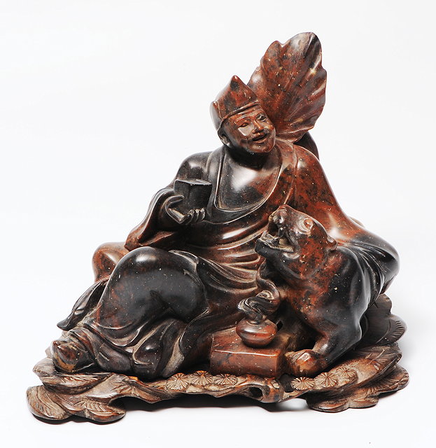 Appraisal: A CHINESE SOAPSTONE SCULPTURE carved with an Oriental figure seated