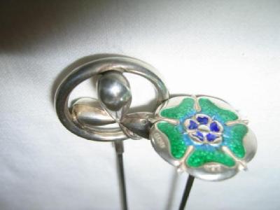 Appraisal: TWO SILVER HAT PINS one modelled as a rose and