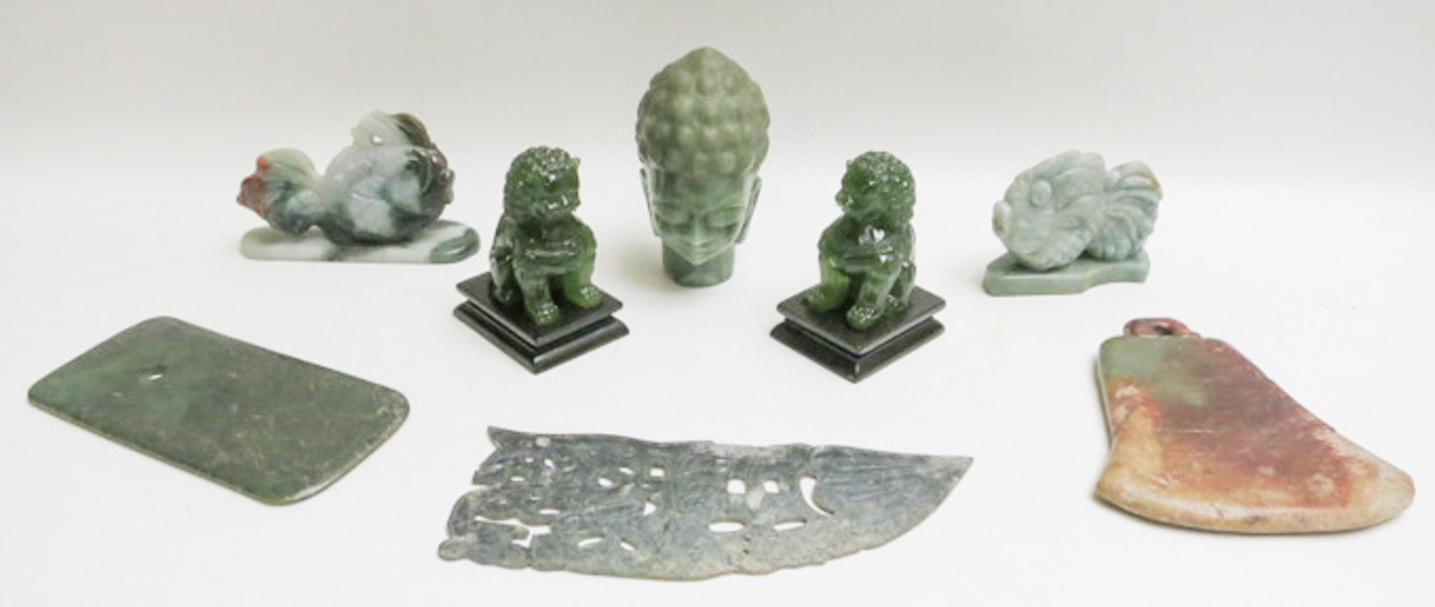 Appraisal: EIGHT CHINESE CARVINGS pair of jade fish on applied matching