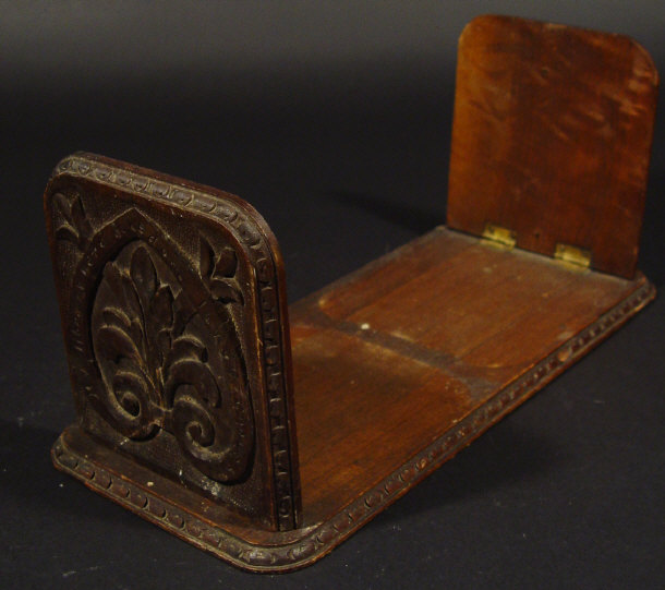 Appraisal: Oak bookslide the end panels carved with a heraldic crest