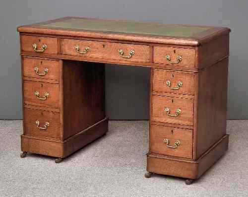 Appraisal: A Victorian oak kneehole desk with green leather inset to