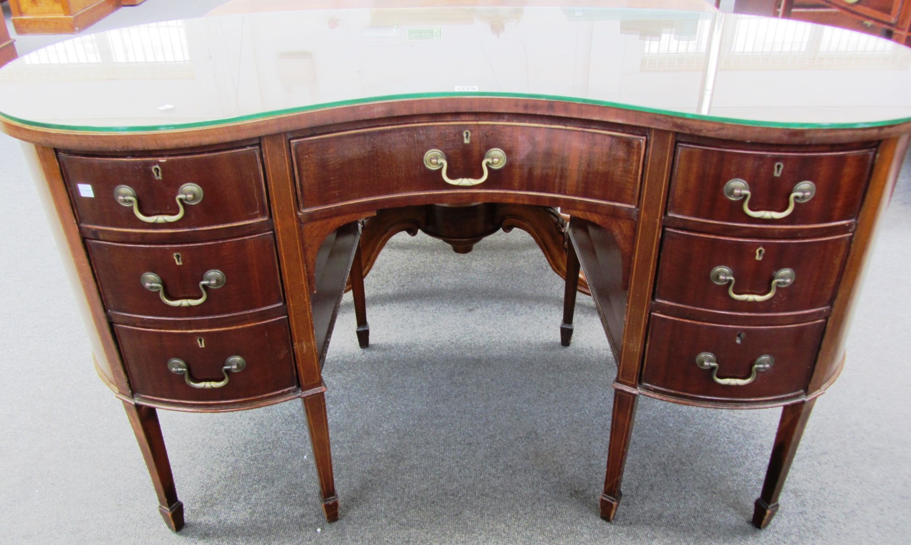 Appraisal: A th century inlaid mahogany kidney shaped writing desk with