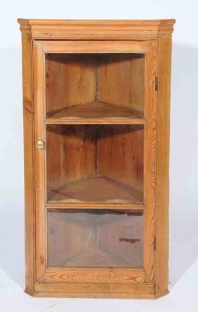 Appraisal: AN OLD PINE HANGING CORNER CABINET the glazed doors enclosing