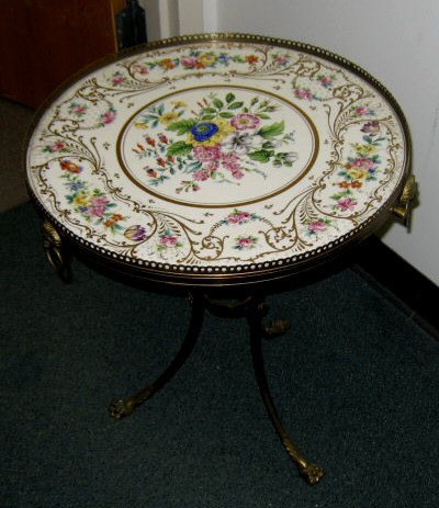 Appraisal: CONTINENTAL PORCELAIN DRINKS TABLE Circular gilt highlighted top hand painted