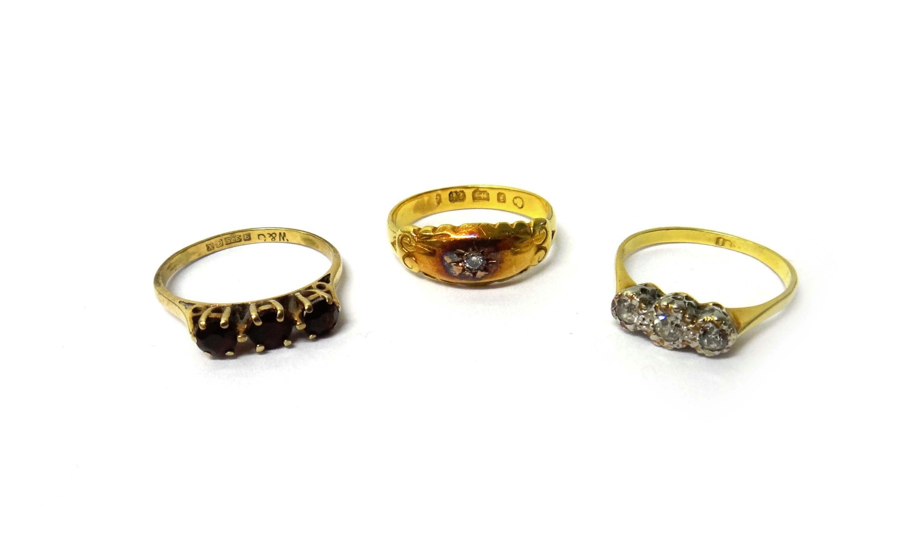 Appraisal: A gold and diamond three stone ring mounted with a