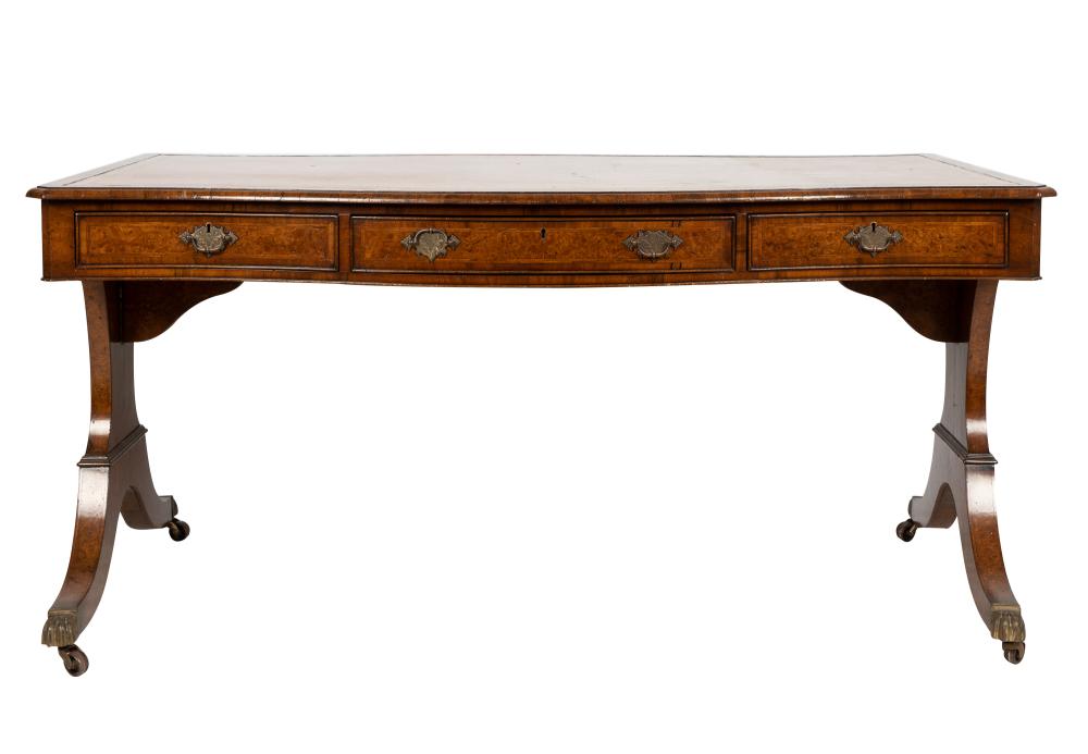 Appraisal: ENGLISH REGENCY LIBRARY TABLEthe serpentine rectangular top inset with gilt-tooled