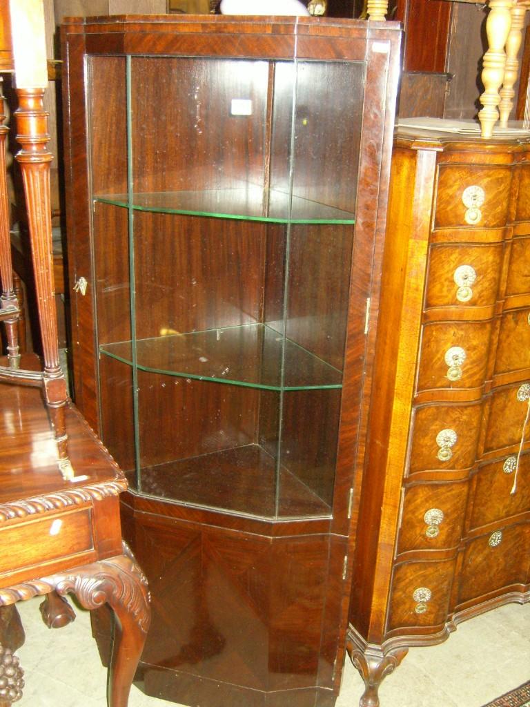 Appraisal: An Art Deco style mahogany free standing corner display cabinet