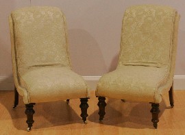 Appraisal: A pair of Victorian walnut and upholstered lounge chairs