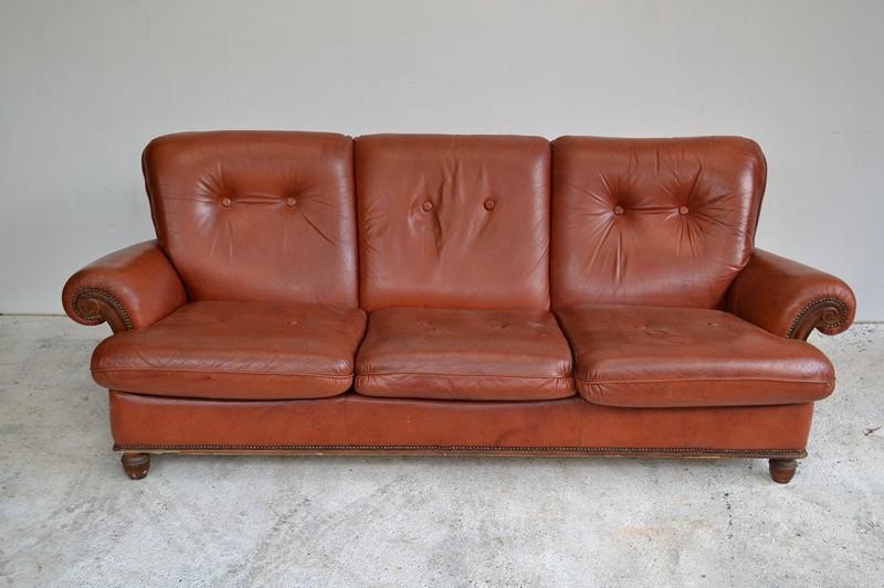 Appraisal: A MID CENTURY THREE SEAT CHESTERFIELD SOFA IN BURNT ORANGE