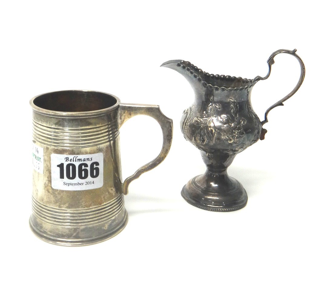 Appraisal: A silver christening mug decorated with reeded bands and presentation