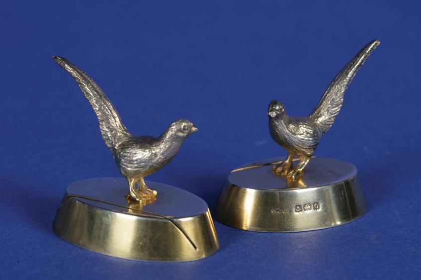 Appraisal: A PAIR OF SILVER GILT MENU CARD HOLDERS modelled in