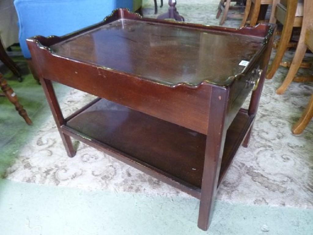 Appraisal: A mahogany two tier tray top occasional table in the