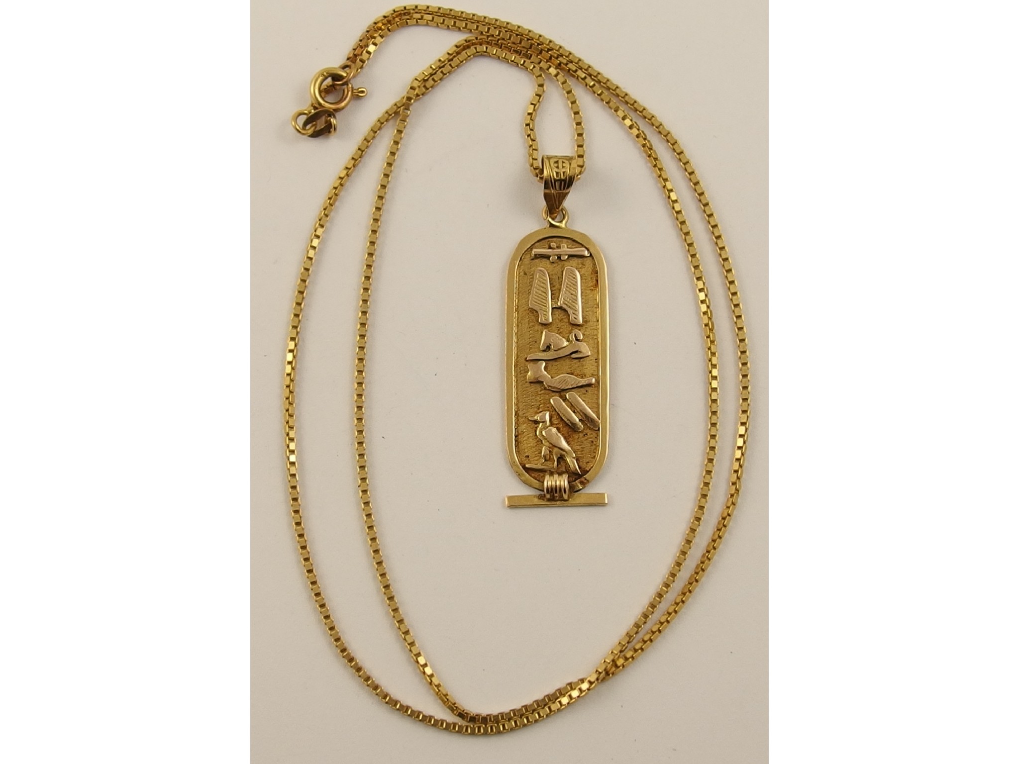 Appraisal: An Egyptian hieroglyph style pendant with Arabic hallmarks together with