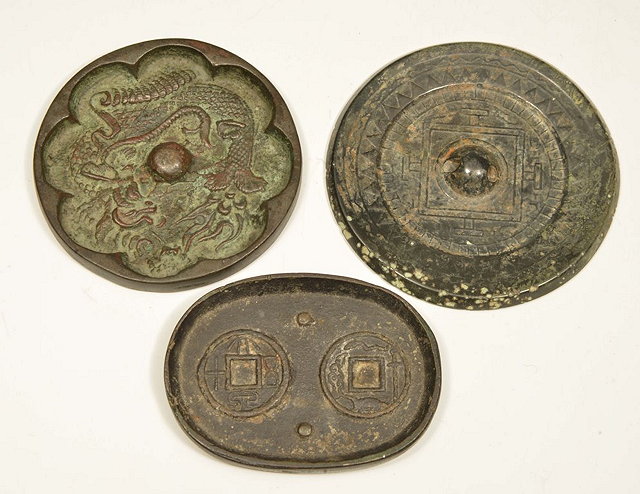 Appraisal: A CHINESE BRONZE MIRROR with tea pattern motif Tang dynasty