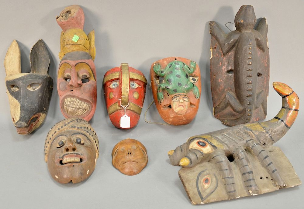 Appraisal: Eight wooden hand carved tribal masks to include a lizard