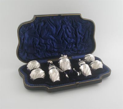 Appraisal: A Victorian seven piece condiment set comprising four salts lacking