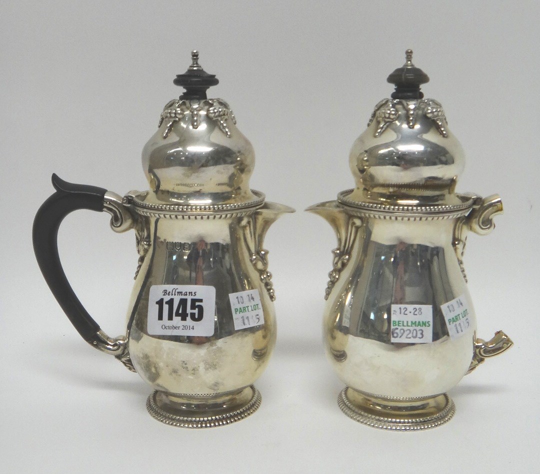 Appraisal: A pair of silver small chocolate pots each of baluster