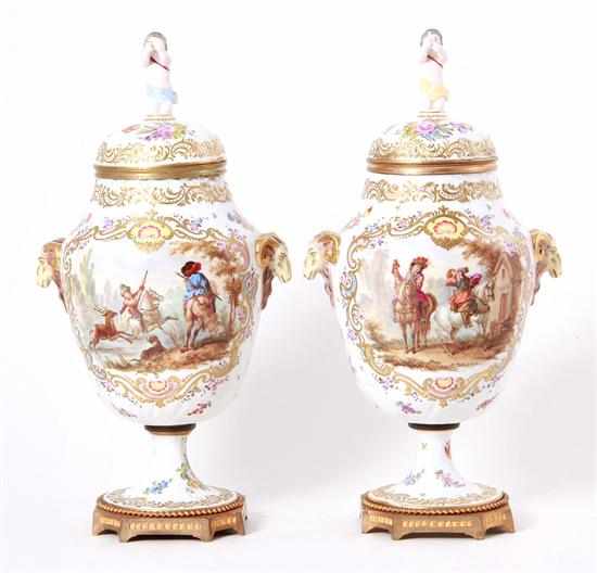 Appraisal: Pair Continental porcelain covered urns figural finial dome cover on