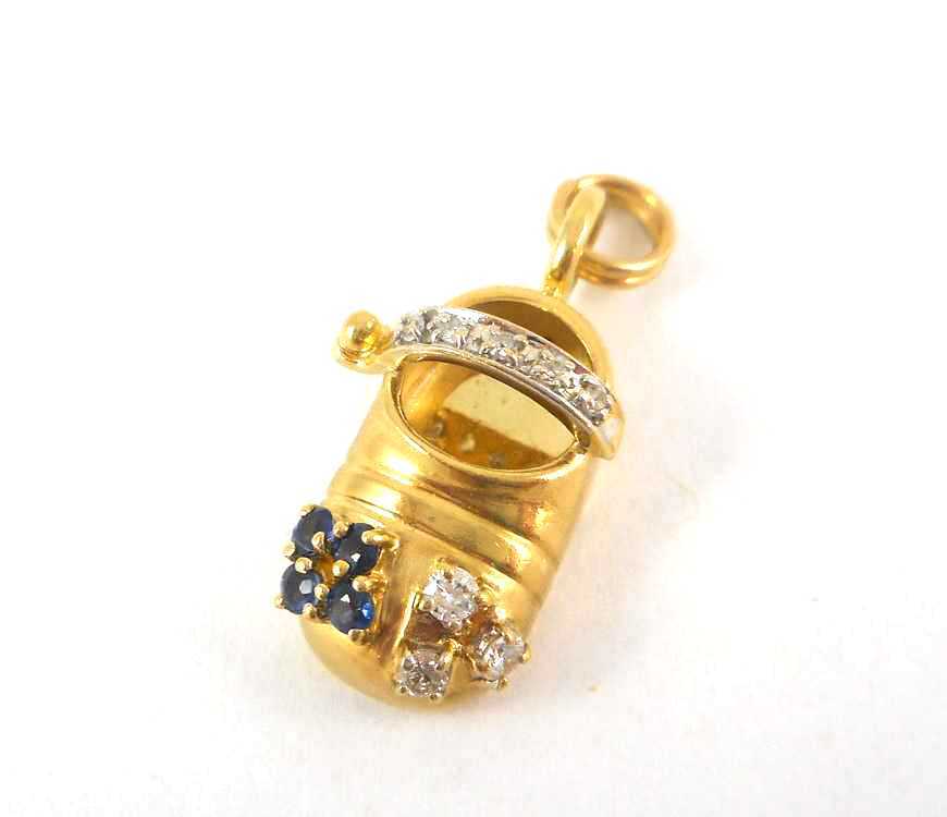 Appraisal: SAPPHIRE DIAMOND AND FOURTEEN KARAT GOLD CHARM The yellow gold