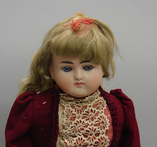 Appraisal: Turned solid dome shoulderhead doll Stationary blue eyes CLOSED mouth