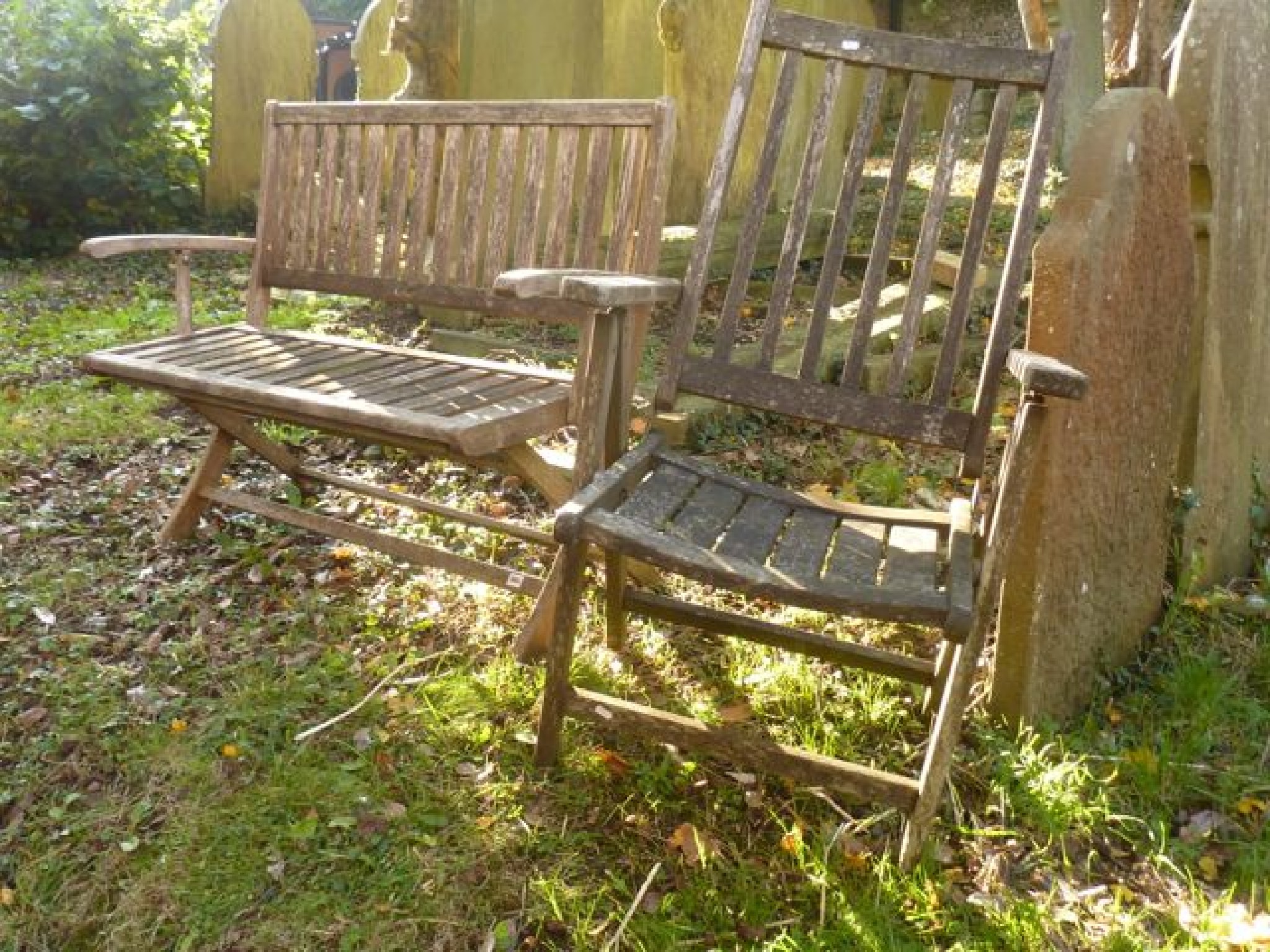 Appraisal: A weathered two seat folding garden bench with slatted seat