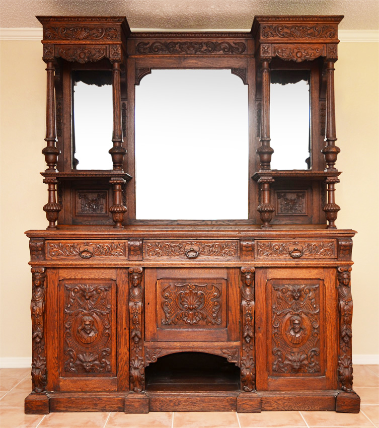 Appraisal: A GRAND FIGURAL CARVED OAK SIDEBOARD Carved and applied decoration