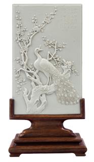 Appraisal: A WHITE BISCUIT GLAZED PORCELAIN PLAQUE WITH A PEACOCK AND