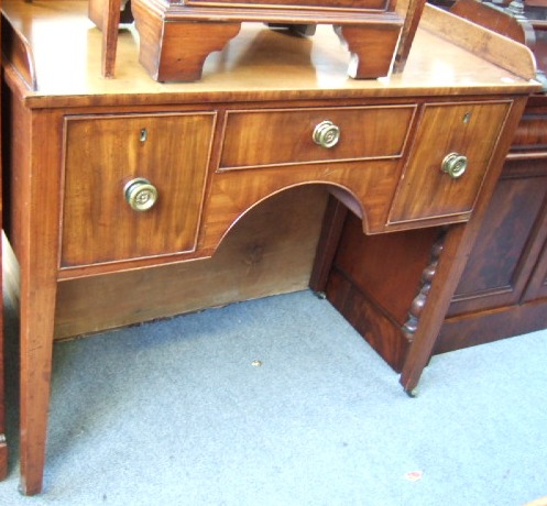 Appraisal: An early th century mahogany knee hole writing desk the