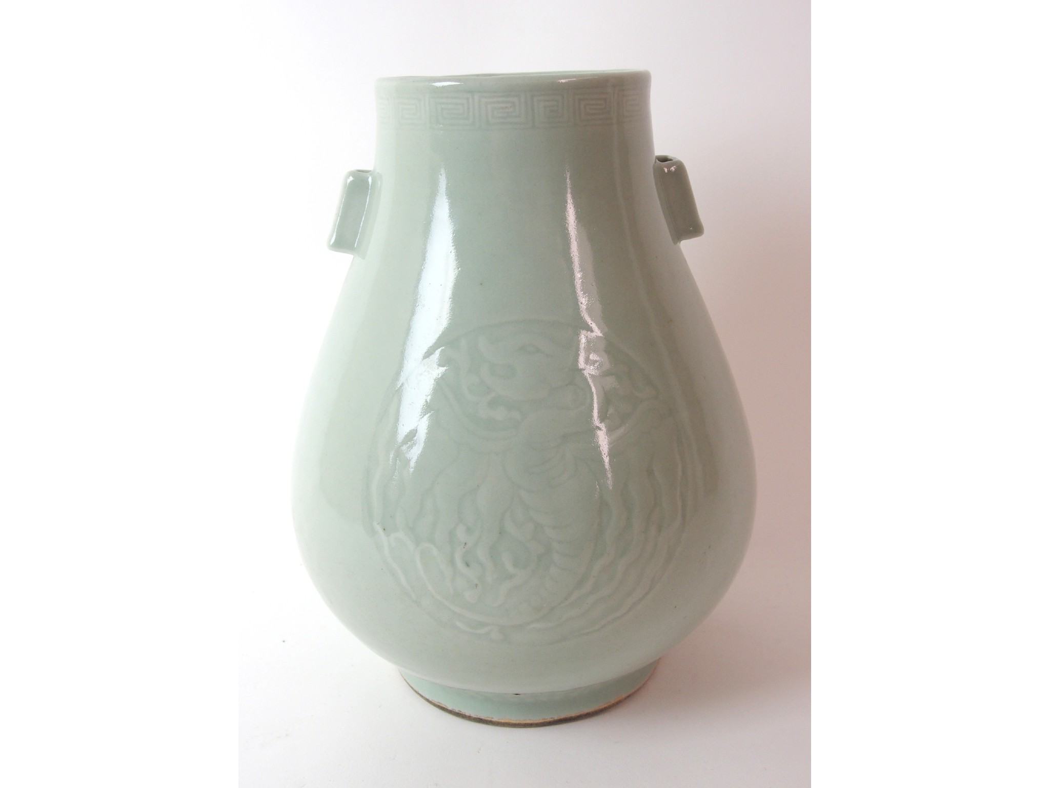 Appraisal: A Chinese celadon archers vasecarved with two roundels of phoenix