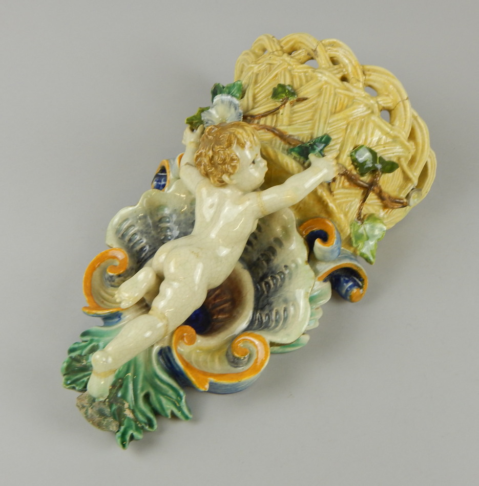 Appraisal: A thC Majolica pottery wall pocket with a shaped part