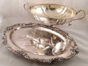 Appraisal: A silver plated footed oval bowl with sea monster handles