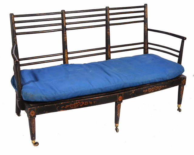 Appraisal: A REGENCY BLACK LACQUERED TWO SEATER SOFA with horizontal spindle