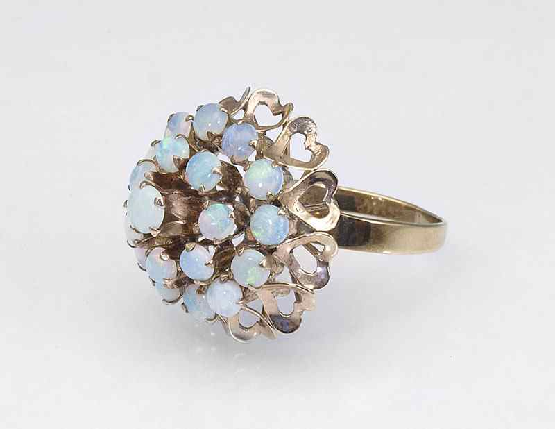 Appraisal: TWENTY OPAL HAREM TYPE RING K yellow gold ring contains