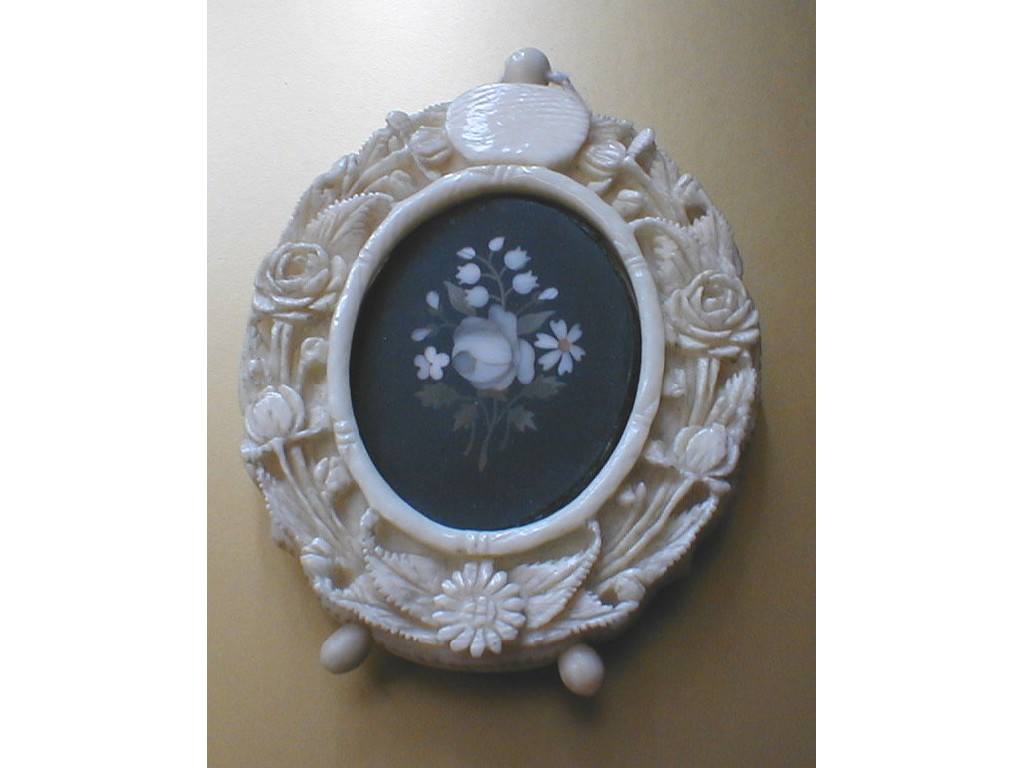 Appraisal: A Victorian ivory oval pendant easel frame intricately carved with