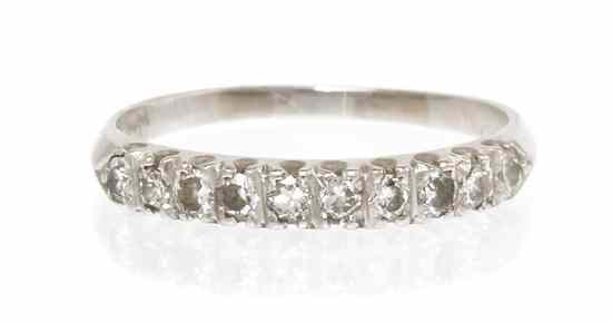 Appraisal: A Platinum and Diamond Band containing round brilliant diamonds weighing