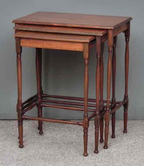 Appraisal: A nest of three Edwardian mahogany rectangular occasional tables inlaid