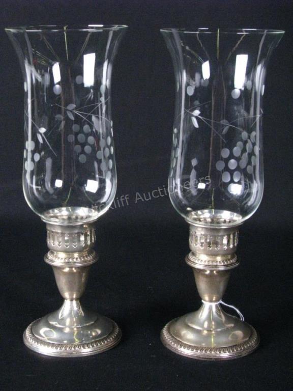 Appraisal: Empire Weighted Sterling Glass Hurricanes weighted sterling bases with pierced