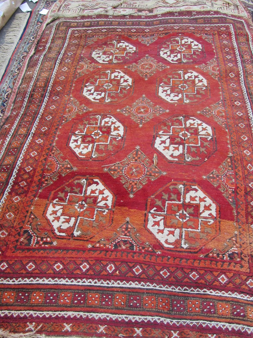 Appraisal: An Afghan rug the madder field with four pairs of