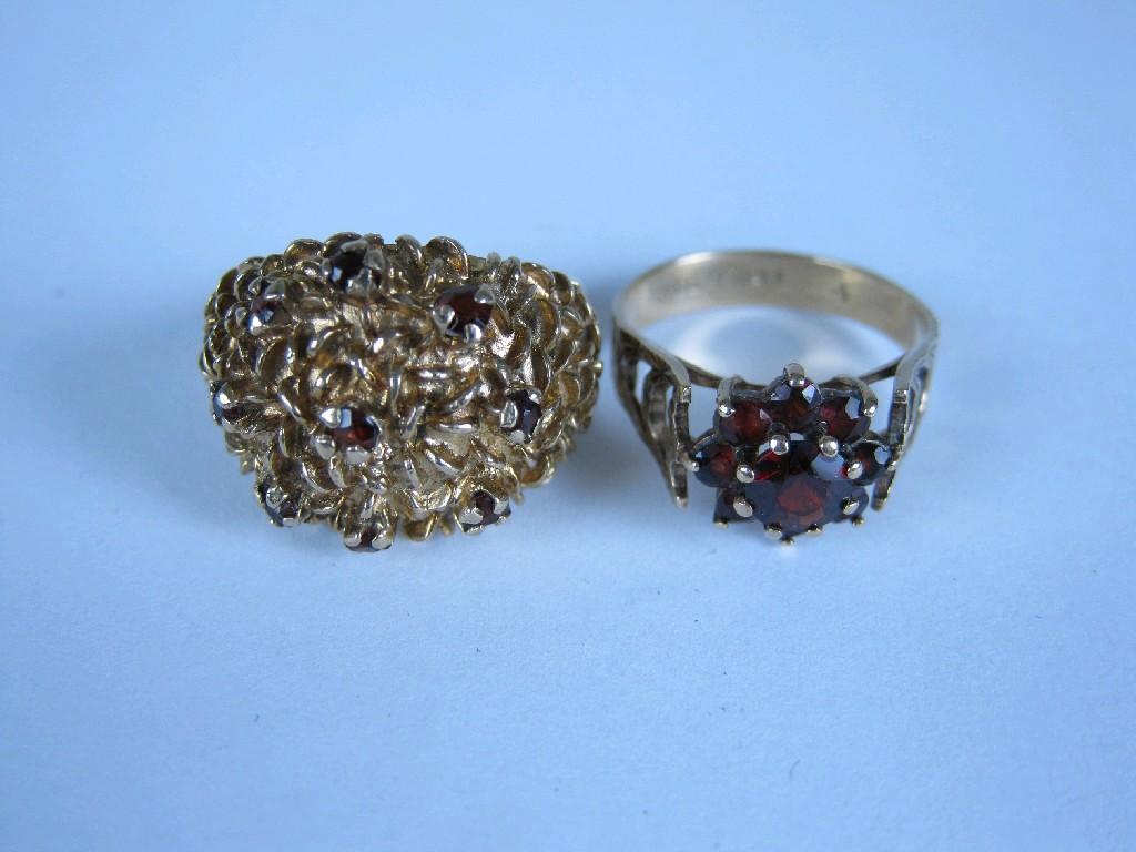 Appraisal: A Bomb Ring claw-set circular-cut garnets in textured ct gold